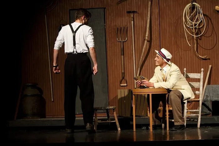 Playing the role of Ali Hakim in the musical “Oklahoma!” (sitting)